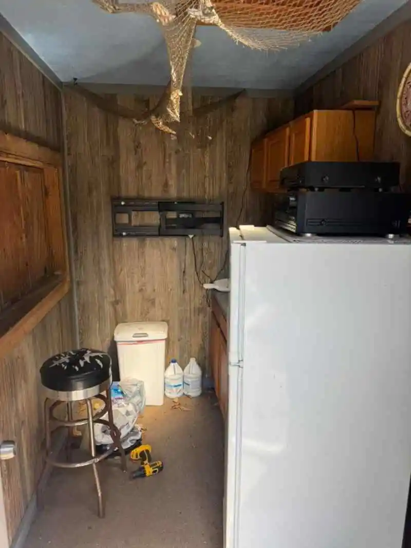 Refrigerator inside an apartment kitchen before removal