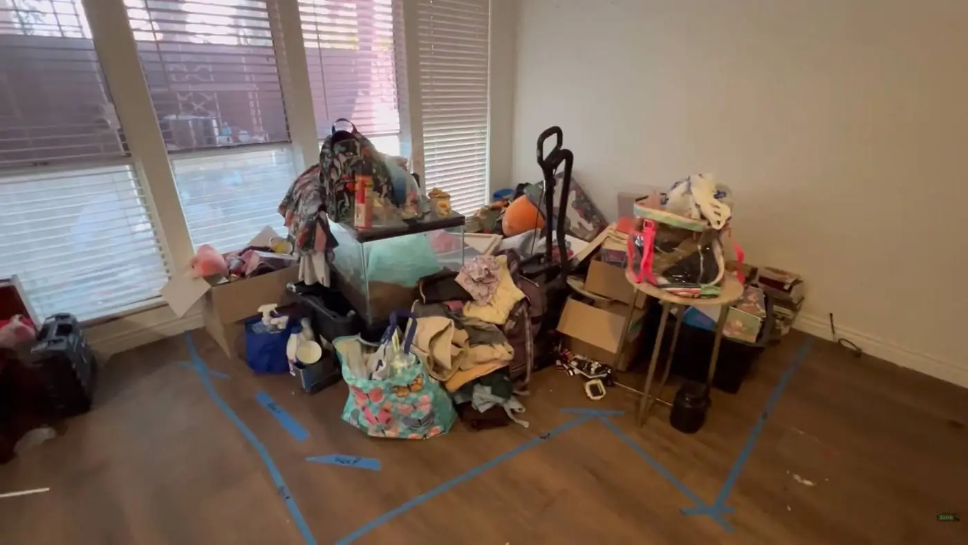Apartment room with unwanted household items gathered for removal